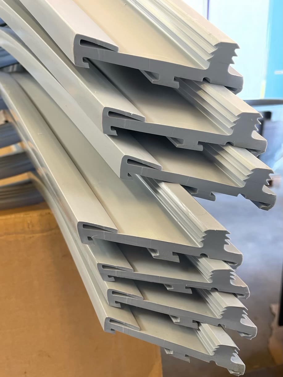Stack of complexly shaped grey silicone rubber parts