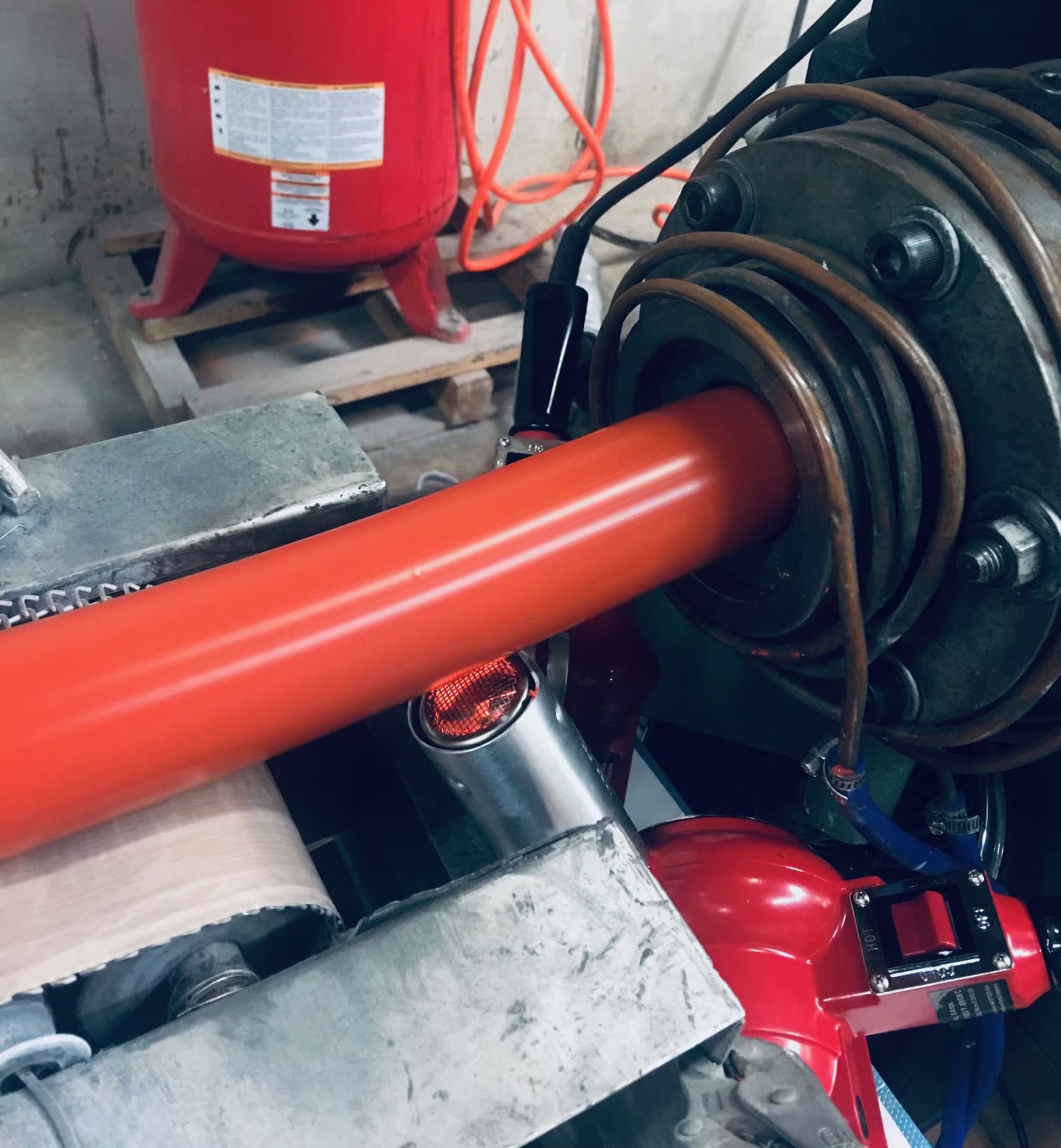 Large red silicone rubber cord being extruded.