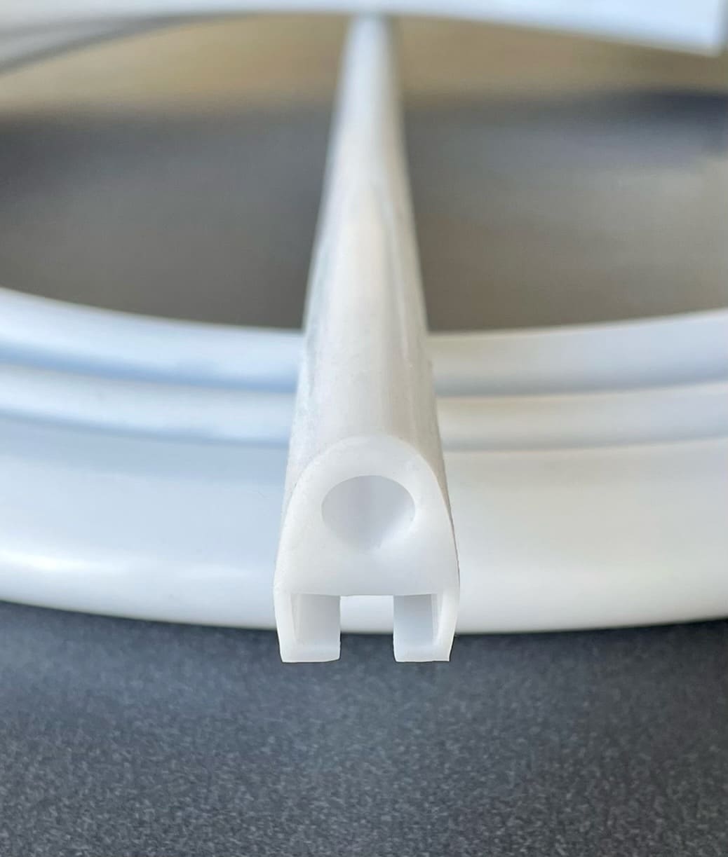White extruded silicone rubber profile shaped like a ghost