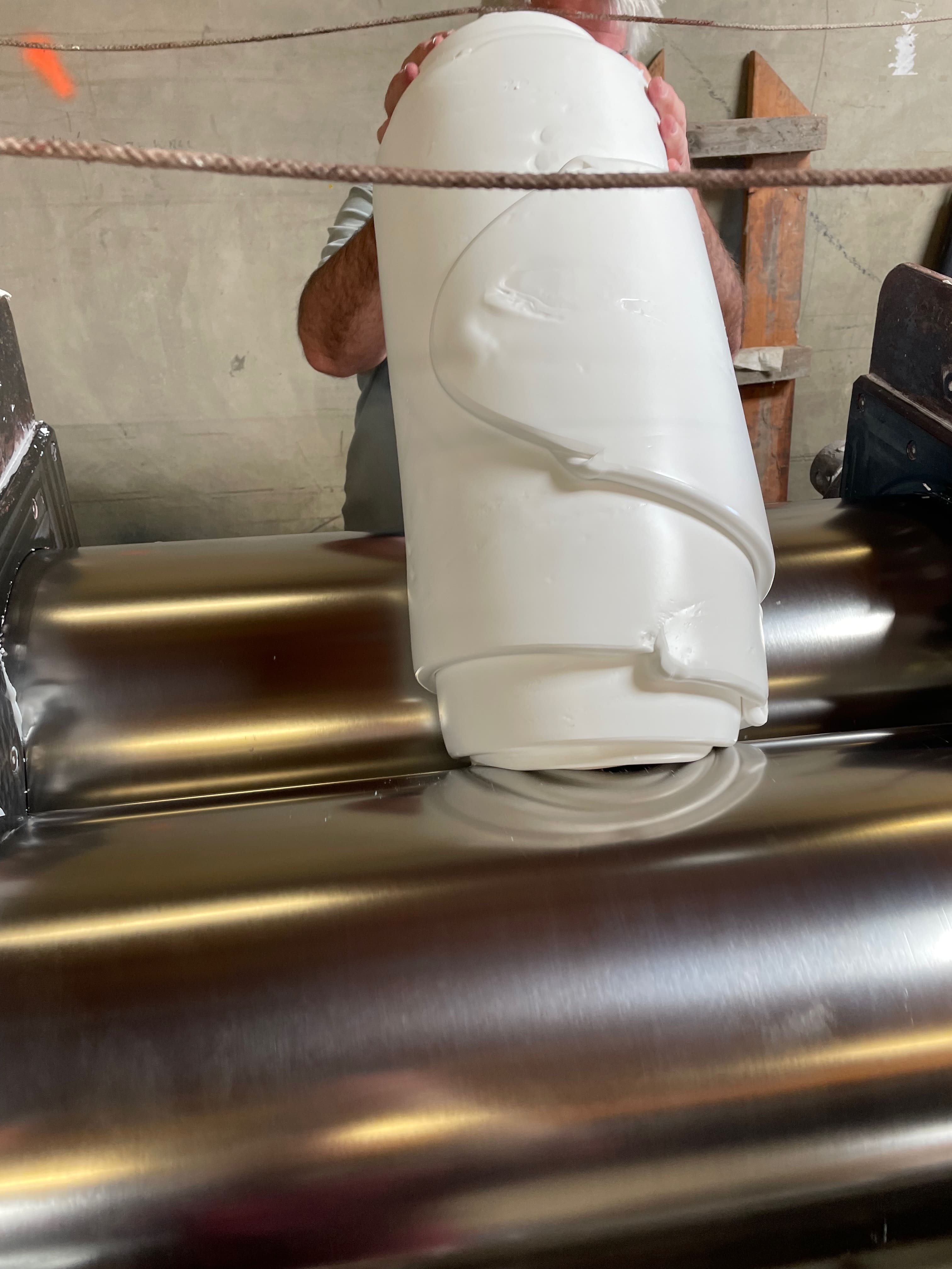 White silicone rubber base material being mixed in a mixing mill